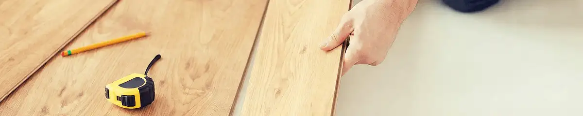 A professional installing wood flooring in Ogden, UT