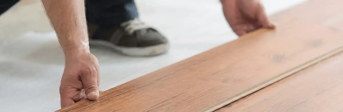 A professional installing laminate flooring in Ogden, UT