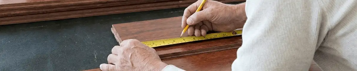 A professional installing wood flooring in Ogden, UT